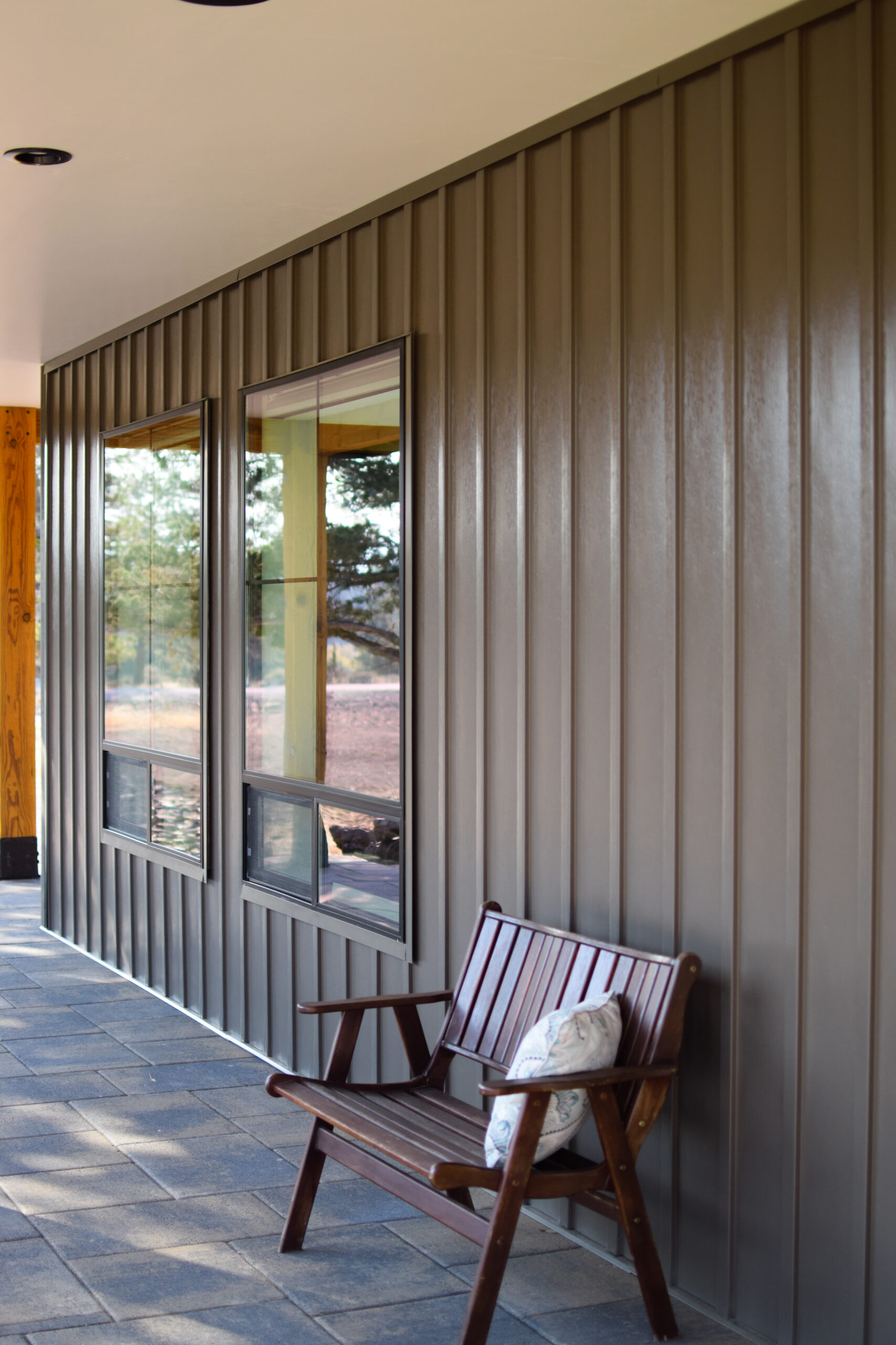Covered patio with standing seam siding and window lines